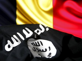 Islamic State flag is seen in front of a Belgian flag in this illustration taken March 22, 2016. REUTERS/Dado Ruvic/Illustration