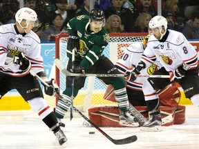 London Knight Matthew Tkachuk tries to tip a point shot while positioned between Owen Sound Attack defenceman Jacob Friend and Santino Centorame during Game 1 of their Ontario Hockey League Western Conference best-of-seven quarterfinal series at Budweiser Gardens Friday. The Knights won 4-1. (DEREK RUTTAN, The London Free Press)