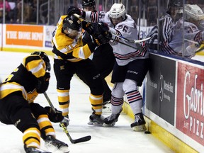 Kingston Frontenacs' Cody Caron and Oshawa Generals' Daniel Robertson get physical during the first period of the Ontario Hockey League Eastern Conference quarter-final series at the Rogers K-Rock Centre in Kingston on Friday. (Steph Crosier/The Whig-Standard)