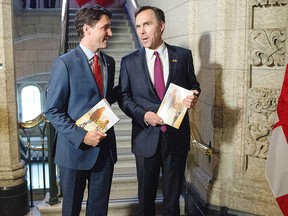 Prime Minister Justin Trudeau (left) speaks with Minister of Finance Bill Morneau as he arrives to table the budget on Parliament Hill, Tuesday, March 22, 2016 in Ottawa. THE CANADIAN PRESS/Justin Tang