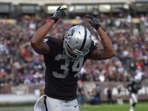 George Atkinson #34 of the Oakland Raiders celebrates a touchdown against the Buffalo Bills in the fourth quarter at O.co Coliseum on December 21, 2014 in Oakland, California. (Thearon W. Henderson/Getty Images/AFP)