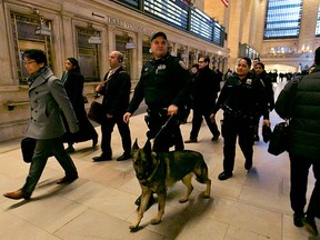 In this March 22, 2016 file photo, Metro-North Railroad police officers with a police dog patrol Grand Central Terminal, in New York.  (AP Photo/Richard Drew)
