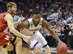 Kansas guard Wayne Selden Jr. drives on Maryland forward Jake Layman during the second half of an NCAA college basketball game in the regional semifinals of the men's NCAA Tournament, in Louisville, Ky., Thursday, March 24, 2016. Kansas won 79-63. (AP Photo/John Flavell)