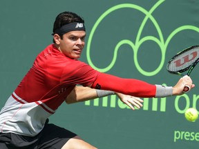 Milos Raonic returns a shot to Denis Kudla during their match at the Miami Open Saturday, March 26, 2016, in Key Biscayne, Fla. (AP Photo/Lynne Sladky)