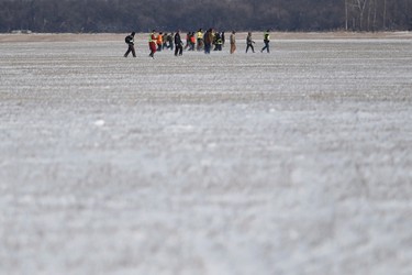 Volunteers search through a farmers' field hoping to find 2 year old Chase Martens near Austin, Man., on Friday, March 25, 2016. An overnight snowfall is making the search, a race against time in locating the missing bow, even more difficult. THE CANADIAN PRESS/John Woods