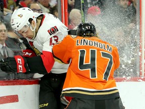 Anaheim's Hampus Lindholm checks Senators' Nick Paul into the boards on March 26. (Julie Oliver, Postmedia Network)