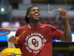 Oklahoma guard Buddy Hield cuts down the net after their win over Oregon during the regional final of the NCAA Tournament Saturday, March 26, 2016, in Anaheim, Calif. (AP Photo/Mark J. Terrill)