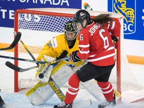 Canada's Rebecca Johnston is stopped by Sweden goaltender Minatsu Murase during a pre-tournament game at the women's world hockey champioships Saturday, March 26, 2016 in Kamloops, B.C. THE CANADIAN PRESS/Ryan Remiorz