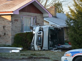 A pickup flipped end over end and crashed into this Oxford St. home early Sunday. John Miner/The London Free Press/Postmedia Network