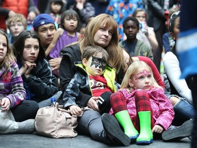 Karen Cinq-Mars takes in a performance by The Silly People with son Jake Adams, 4, and daughter Eva Adams, 4, during the 15th annual Festival of Fools put on by the Winnipeg International Children's Festival at the Forks on Sat., March 28, 2015.