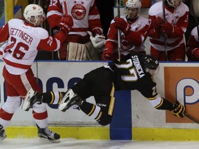 Sam Studnicka is sent flying after a collision with Timmy Gettinger of the Sault Ste. Marie Greyhounds during Game 2 of the Ontario Hockey League Western Conference quarter-final on Sunday March 27, 2016 in Sarnia, Ont. Terry Bridge/Sarnia Observer/Postmedia Network