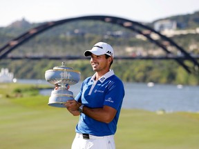 Jason Day, of Australia, poses with his trophy after defeating Louis Oosthuizen, of South Africa, in the final round the Dell Match Play Championship golf tournament at Austin County Club, Sunday, March 27, 2016, in Austin, Texas. (AP Photo/Eric Gay)