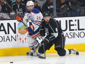 Edmonton Oilers forward Jordan Eberle and Los Angeles Kings defenceman Jake Muzzin fight for position on Saturday at Staples Center. (Jayne Kamin-Oncea/USA TODAY Sports)
