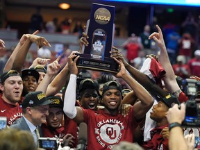 Sooners guard Buddy Hield (centre) holds the trophy after their win against Oregon on Saturday. Some think Hield could be a top-five pick in the NBA draft this summer. (AP)