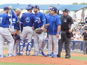 Blue Jays starting pitcher Drew Hutchison draws a crowd after being hit in the head on a throw to second by catcher AJ. Jiminez yesterday in Port Charlotte while playing the Rays. (Eddie Michels/photo)
