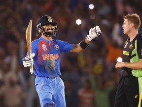 India’s Virat Kohli (left) celebrates at the end of his team’s win over James Faulkner (right) and Australia in the world Twenty20 cricket tournament on March 27, 2016, in Mohali, India. The host nation’s team advanced to the tournament semifinal, where it will play against the West Indies.(ADNAN ABIDI/Reuters)