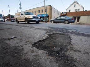 Potholes are pictured on Queenston St. in St. Catharines in this Jan. 27, 2016 file photo. An annoying sign of spring -- the dreaded pothole -- is testing the patience of Canadian drivers this year while also creating a financial bonanza for auto repair shops. (Julie Jocsak/St. Catharines Standard/Postmedia Network)