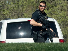 A Secret Service Police Officer patrols the North Lawn of the White House in Washington, Monday, March 28, 2016, after reports of an active shooter at the U.S. Capitol. A U.S. Capitol Police officer was shot and injured Monday, March 28, 2016,  at the Capitol Complex. The officer was not seriously injured and the shooter was caught and is in custody, Capitol officials said.  (AP Photo/Jacquelyn Martin)
