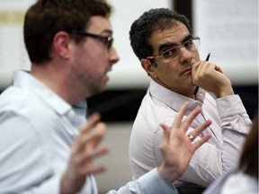 Amir Attaran, a professor at the University of Ottawa faculty of law and medicine, listens to Ottawa-Carleton District School Board trustee Shawn Menard, left, at a public meeting about crowding at Elgin Street Public School. Attaran warns that a school board decision to move kindergarten kids out of the school violates provincial law. DARREN BROW