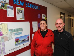 Cori-Lyn Carroll, a parent Frontenac Public School and member of the integration committee, and principal Michael Blackburn stand by the schools 'new school' board with the design and logos for Molly Brant Elementary School in Kingston, Ont. on Thursday March 24, 2016. The students and staff will amalgamate with First Avenue Public School in the new Molly Brant Elementary School, this fall. Julia McKay/The Whig-Standard/Postmedia Network
