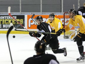 Kingston Frontenacs’ Spencer Watson, left, chases the puck while teammate Stephen Desrocher laughs at practice on Monday at the Rogers K-Rock Centre as the Frontenacs prepare for Game 3 of their Ontario Hockey League Eastern Conference quarter-final series against the Generals in Oshawa on Tuesday. (Ian MacAlpine/The Whig-Standard)