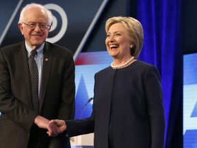 Democratic presidential candidates, Hillary Clinton and Sen. Bernie Sanders, I-Vt,  shake hands before the start of the Univision, Washington Post Democratic presidential debate at Miami-Dade College on Wednesday, March 9, 2016, in Miami, Fla. (AP Photo/Wilfredo Lee)
