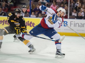 Brandon Baddock of the Edmonton Oil Kings is slowed down by Mitch Wheaton of the Brandon Wheat Kings at Rexall Place in Edmonton on Jan. 26, 2016.