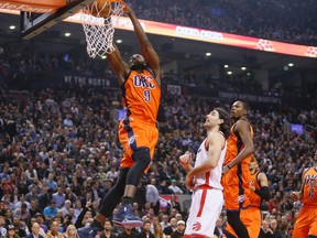 Oklahoma City Thunder forward Serge Ibaka makes a basket as Toronto Raptors forward Luis Scola looks on during first-half action at the Air Canada Centre in Toronto on March 28, 2016. (John E. Sokolowski/USA TODAY Sports)