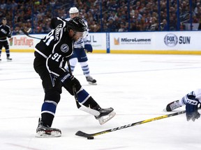 Tampa Bay Lightning centre Steven Stamkos shoots as Toronto Maple Leafs defenceman Morgan Rielly defends during second-period NHL action at Amalie Arena in Tampa, Fla., on March 28, 2016. (Kim Klement/USA TODAY Sports)