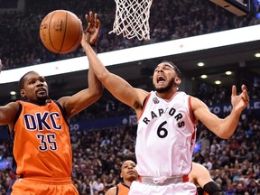 Toronto Raptors’ Cory Joseph (right) gets blocked by the Thunder’s Kevin Durant at the Air Canada Centre last night. (Canadian Press)