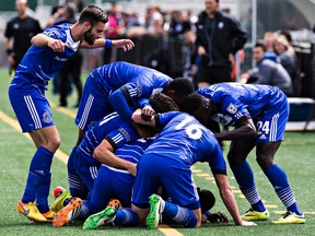 Edmonton players celebrate Lance Laing's goal during FC Edmonton's NASL soccer game against the Carolina Railhawks at Clarke Field in Edmonton, Alta. on Sunday, Aug. 16, 2015.