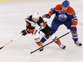 Edmonton's Mark Fayne (5) battles Anaheim's Andrew Cogliano (7) during the third period of an NHL game between the Edmonton Oilers and the Anaheim Ducks at Rexall Place in Edmonton, Alta., on Monday March 28, 2016.