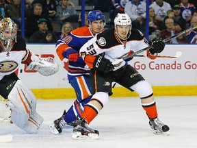 Edmonton Oilers forward Nail Yakupov (10) and Anaheim Ducks defensemen Shea Theodore (53) battle in front of  goaltender John Gibson (36) during the first period at Rexall Place.