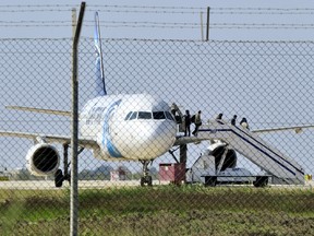 Passengers evacuate a hijacked EgyptAir Airbus 320 plane at Larnaca airport, Cyprus, on March 29, 2016. (REUTERS/Stringer)