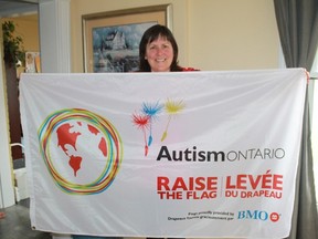 Autism Ontario Sarnia-Lambton's  Kathleen Foubister raises a flag for World Autism Awareness Day, which takes place on Saturday, Apr. 2.
CARL HNATYSHYN/SARNIA THIS WEEK