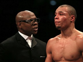 Chris Eubank Sr. (left) speaks to his son Chris Eubank Jr. (right) at the O2 Arena in London on Feb. 28, 2015. British boxer Nick Blackwell lies in an induced coma in a hospital in London following a brutal middleweight title fight against Eubank Jr. over the weekend. (Nick Potts/PA via AP)