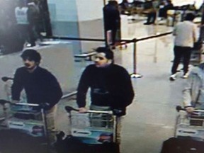 In this image provided by the Belgian Federal Police in Brussels on Tuesday, March 22, 2016, three men who are suspected of taking part in the attacks at Belgium's Zaventem Airport and are being sought by police. The men on both the left and right are yet unidentified, the man at center has been the identified by the Federal Prosecutors office on Wednesday, March 23, 2016 as Ibrahim El Bakraoui. (Belgian Federal Police via AP)