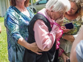 In this photo taken Monday, March 28, 2016, Hazel Priest kisses the dog tag of her late brother, Pfc. Thomas E. Davis, an American serviceman killed in Japan during World War II, after the dog tag was returned to Davis' family by representatives of the Japanese nonprofit Kuentai-USA in Victoria, Texas. Davis, of Roachdale, Ind., served with the Army's 27th Division, a former New York National Guard unit, was killed on the island of Okinawa in 1945. The dog tag was discovered on the Pacific island of Saipan in 2014.  (Leslie Boorhem-Stephenson/The Victoria Advocate via AP)