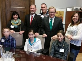 Three students (front) with three parents (left, right and centre back) pose with Drayton Valley-Devon MLA Mark Smith (front left) and Alberta Minister of Education (front right) at the Alberta Legislature where students spent a day and learned about provincial level politics and met various politicians.
