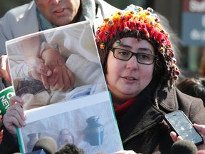 Jennifer Neville-Lake holds pictures of her children Harry and Milly holding hands in hospital before they died. Newmarket court for Marco Muzzo day for sentencing  on March 29, 2016 (Craig Robertson/Toronto Sun/Postmedia Network)