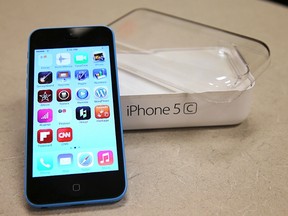 A new Apple iPhone 5C is on display at a Verizon store in Orem, Utah, in this file photo taken September 19, 2013.  The U.S. Justice Department said on Monday it had succeeded in unlocking an Apple iPhone 5C used by one of the San Bernardino shooters and dropped its legal case against Apple, ending a high-stakes legal battle but leaving the broader struggle over encryption unresolved.    REUTERS/George Frey/Files