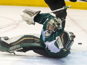 London Knights goalie Tyler Parsons reaches across his crease to deflect a puck wide with his catching glove as he faces shots during a practice at Budweiser Gardens on Tuesday. Parsons has given up three goals in the first three playoff games against Owen Sound and all three have been on Attack power plays. Game 4 is Wednesday in Owen Sound. (CRAIG GLOVER, The London Free Press)