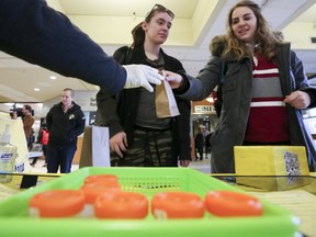 Kinsey Church, left, and Hannah Schneider, University of Ottawa students, part in the Pee to See Challenge at the University of Ottawa Tuesday, March 29, 2016. The challenge was aimed to break a Guiness World Record for the most Chlamydia and gonorrhea urine tests completed within 24 hours in a single venue. (Darren Brown)