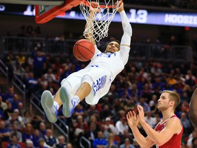 Kentucky’s Jamal Murray hangs from the rim after dunking against Indiana last weekend. The Canadian is expected to be a high pick in this summer’s NBA draft. (AP)