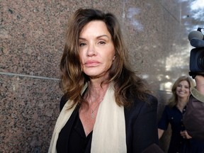 Model Janice Dickinson leaves Los Angeles Superior Court after a judge ruled her defamation lawsuit against Bill Cosby will move forward Tuesday, March 29, 2016. Judge Debre Katz Weintraub said a trial can determine the truthfulness of the model's claims that the comedian raped her in 1982, and the jury can decide the credibility of Dickinson's allegations and whether a statement by Cosby's former lawyer branding her a liar was defamatory. (AP Photo/Nick Ut)