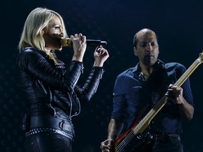 Emily Haines (left) and Joshua Winstead of Metric perform at Rexall Place in Edmonton on Tuesday. (IAN KUCERAK)