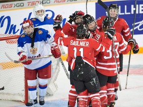 Canada's Meaghan Mikkelson celebrates with teammates after scoring against Russia during second-period action at the women's world hockey championships in Kamloops, B.C. on March 29, 2016. (THE CANADIAN PRESS/Ryan Remiorz)