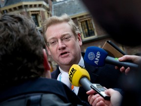 Ard van der Steur answers questions of reporters as he arrives for a cabinet meeting in The Hague, Netherlands, Friday, Jan. 29, 2016. (AP Photo/Peter Dejong)
