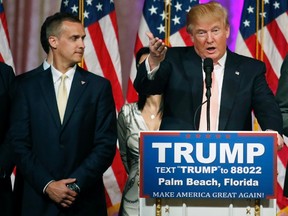 Campaign manager Corey Lewandowski (L) stands next to Republican U.S. presidential candidate Donald Trump  during a news conference in Palm Beach, Florida, in this file photo taken March 15, 2016.  Lewandowski was arrested in Florida on Tuesday and charged with simple battery for intentionally grabbing and bruising the arm of Michelle Fields, police records show.  REUTERS/Joe Skipper/Files