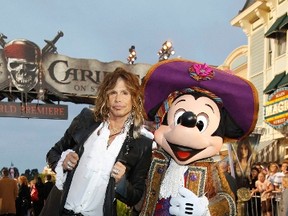 Steven Tyler poses with the Disney character Mickey Mouse at the premiere of "Pirates of the Caribbean: On Stranger Tides" in this May 7, 2011 file photo. REUTERS/Mario Anzuon